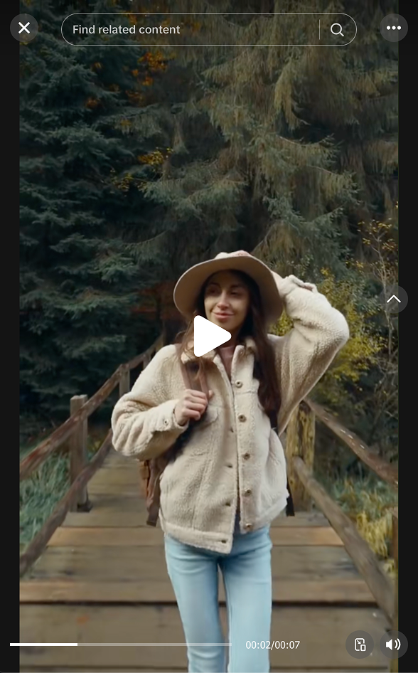Still from a Rooted Earth Travel TikTok reel: a traveller in a wide-brim hat on a forest boardwalk.